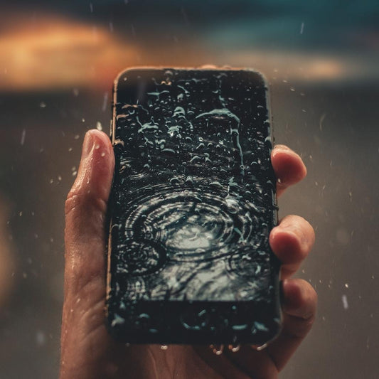 Water drops falling on the phone screen