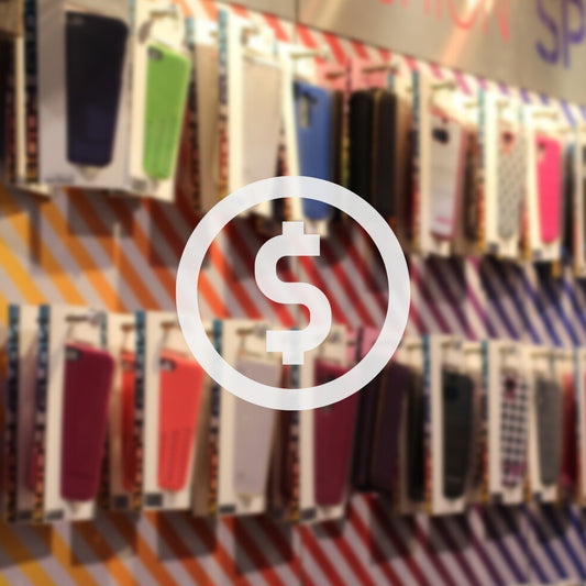 blurred image of phone case shop, money icon in the middle. phone cases hanging on the wall