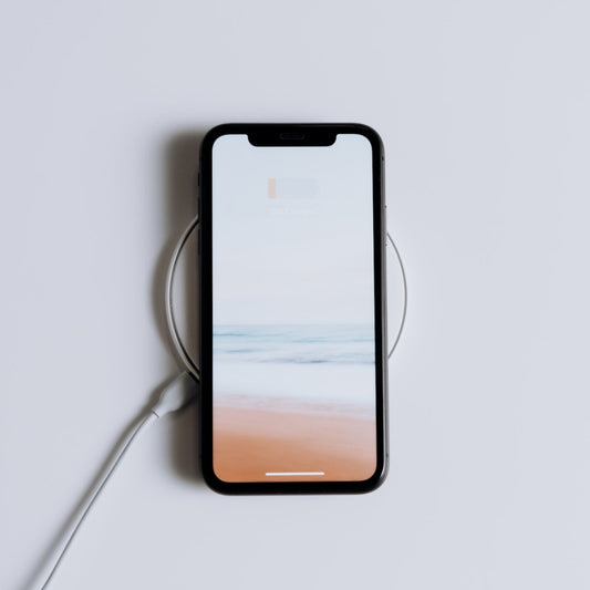 Wireless charging with case on, charging pad, white table